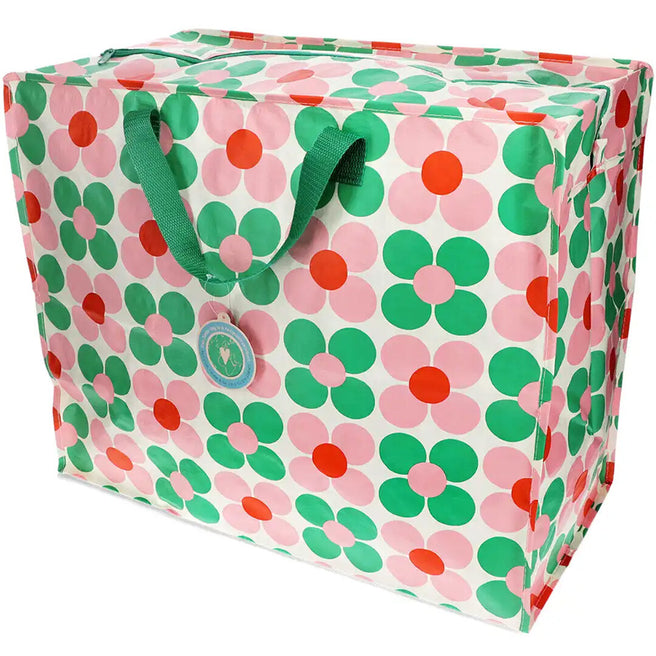 Rex London jumbo opbergtas van plastic met roze en groen margrietpatroon en groene handvatten.