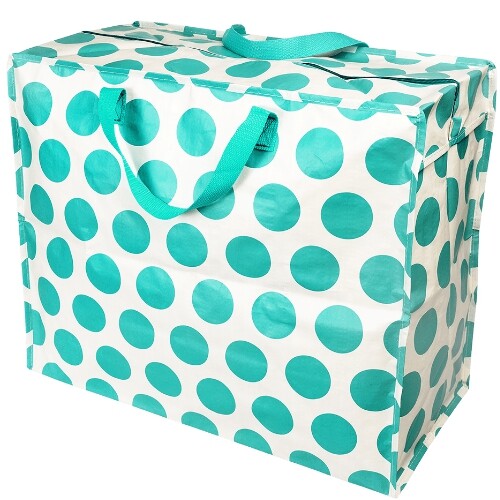 Rex London jumbo opbergtas met turquoise stippen en handvatten, schuin gefotografeerd.