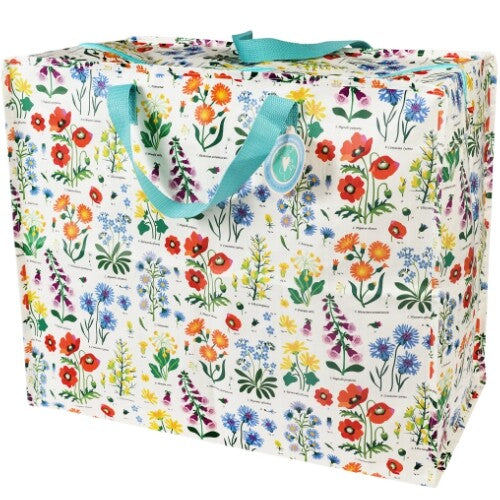 Rex London jumbo opbergtas met wild flowers patroon en blauwe handvatten, schuin gefotografeerd.