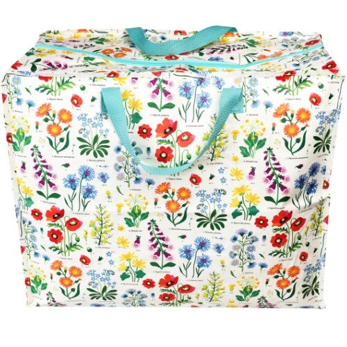 Rex London jumbo opbergtas met wild flowers patroon en blauwe handvatten, van voren gefotografeerd.