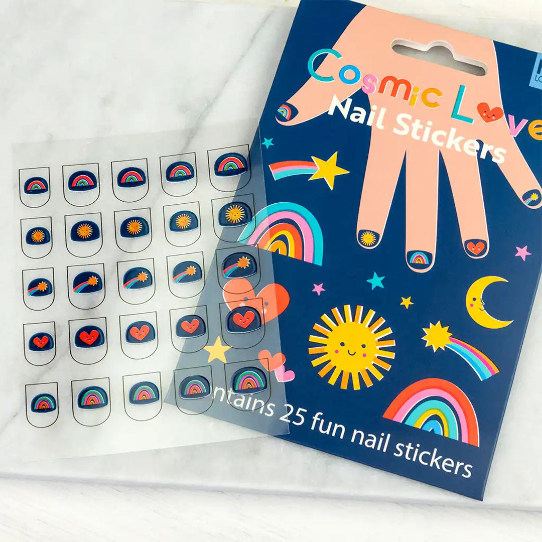 Rex London Cosmic Love nagelstickers verpakking en een vel met diverse kosmische stickers op een lichte ondergrond.