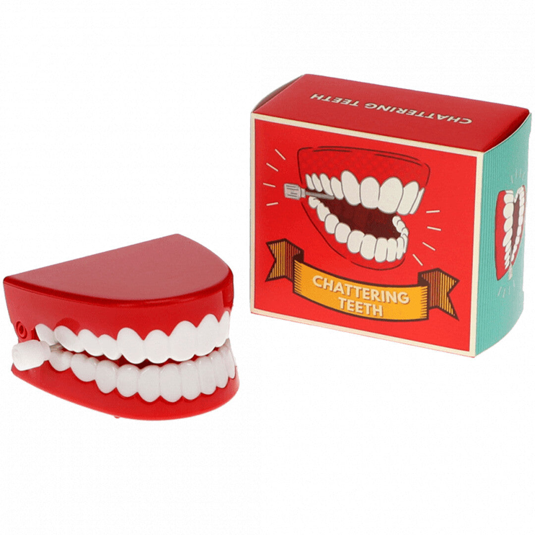 Rex London opwindbaar klapperend gebit van rood plastic naast de verpakking.