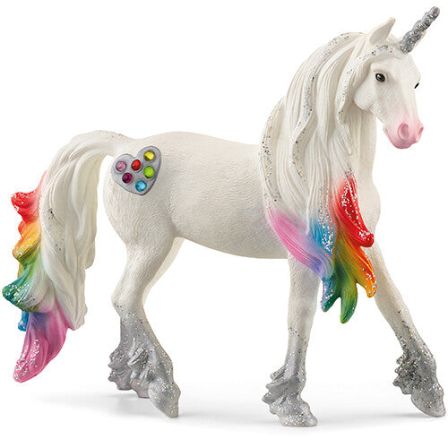 Schleich dierenfiguurtje van een witte eenhoorn met regenboogkleurige manen, staart en een hartvormig palet.