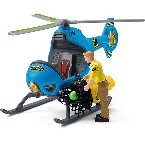 Schleich dinosaurusspeelset met blauwe helikopter en een figuur die een net met een groen ei vasthoudt.
