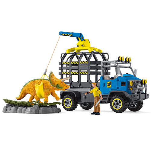 Schleich dinosaurusspeelset met blauwe transporttruck, kraan, triceratops en figuur.