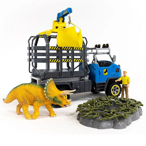 Schleich dinosaurusspeelset met blauwe transporttruck, kraan die een gele zak tilt, triceratops en figuur.