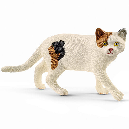 Schleich dierenfiguurtje van een witte Amerikaanse korthaar kat met bruine en zwarte vlekken.