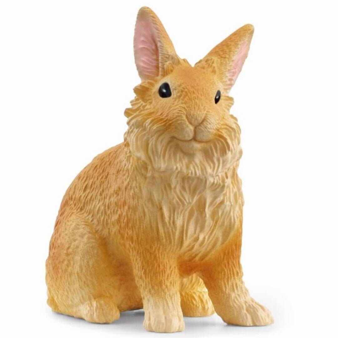 Schleich oranje plastic dierenfiguurtje van een leeuwenkop konijn, schuin van voren gefotografeerd.