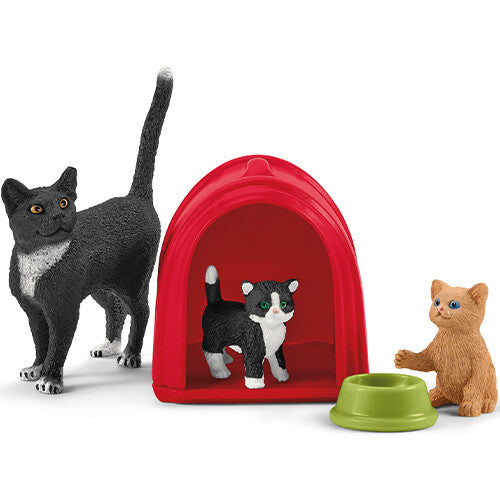 Schleich farm world speelset met zwarte kat, rode kattenmand met zwart-witte kat en bruine kat.