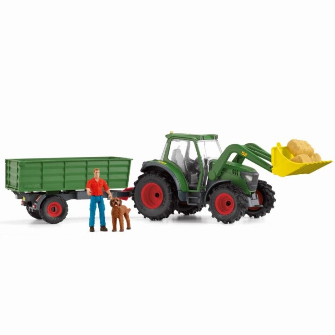 Schleich Farm World speelset met groene tractor met voorlader, aanhangwagen, boer en hond.