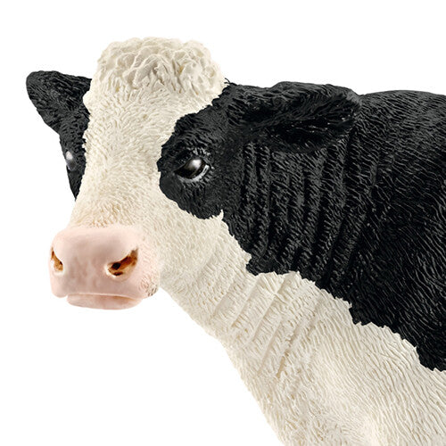 Detailopname van de kop van de Schleich zwartbonte koe.