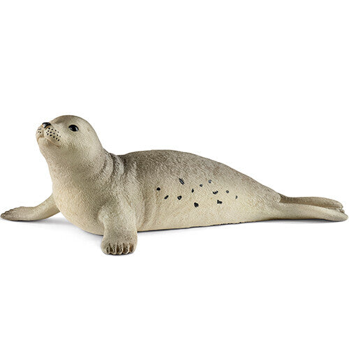 Schleich dierenfiguurtje van een beige zeehond met stippen, liggend op de buik.