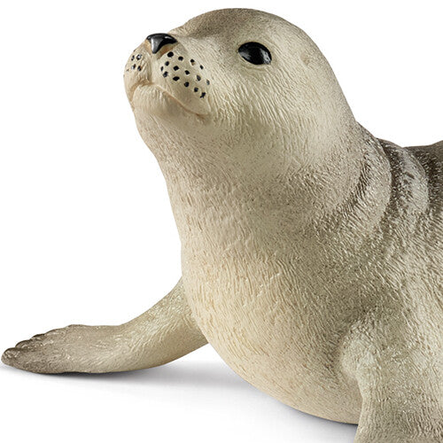 Detailopname van de kop en voorpoten van het Schleich zeehond dierenfiguurtje.