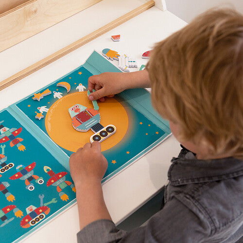 Een kind speelt met het Scratch Europe magnetisch speelgoed en plaatst een robotonderdeel op de maan.