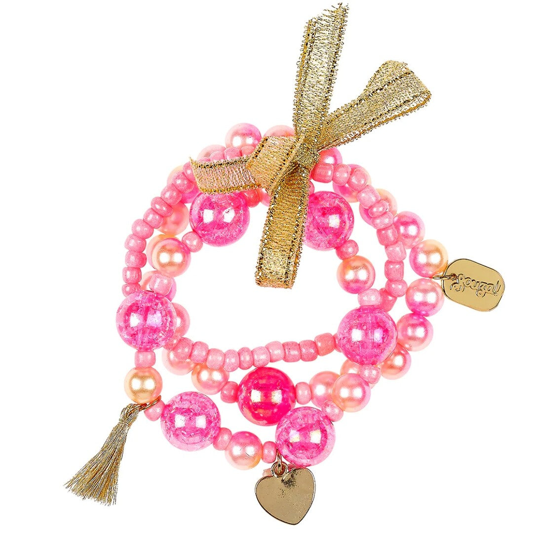 Souza for Kids kinderarmbanden met roze en perzik kralen, een gouden strik en bedeltjes.