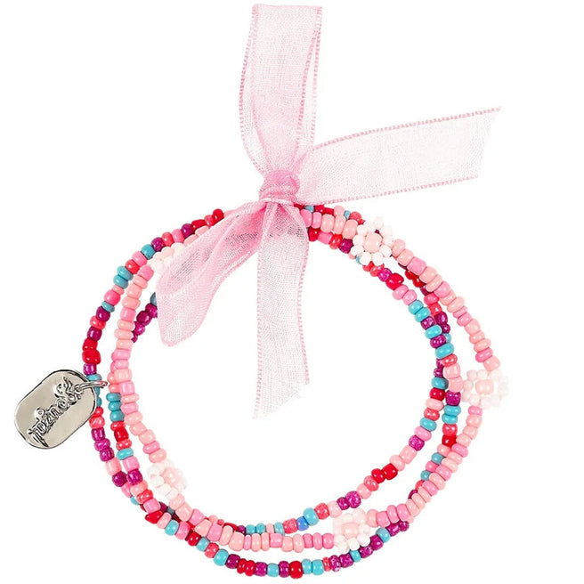 Souza for Kids kinderarmbandenset van drie roze, rode en blauwe kralenarmbanden met bloemkralen en een zilverkleurig bedeltje, samengebonden met een roze lint.