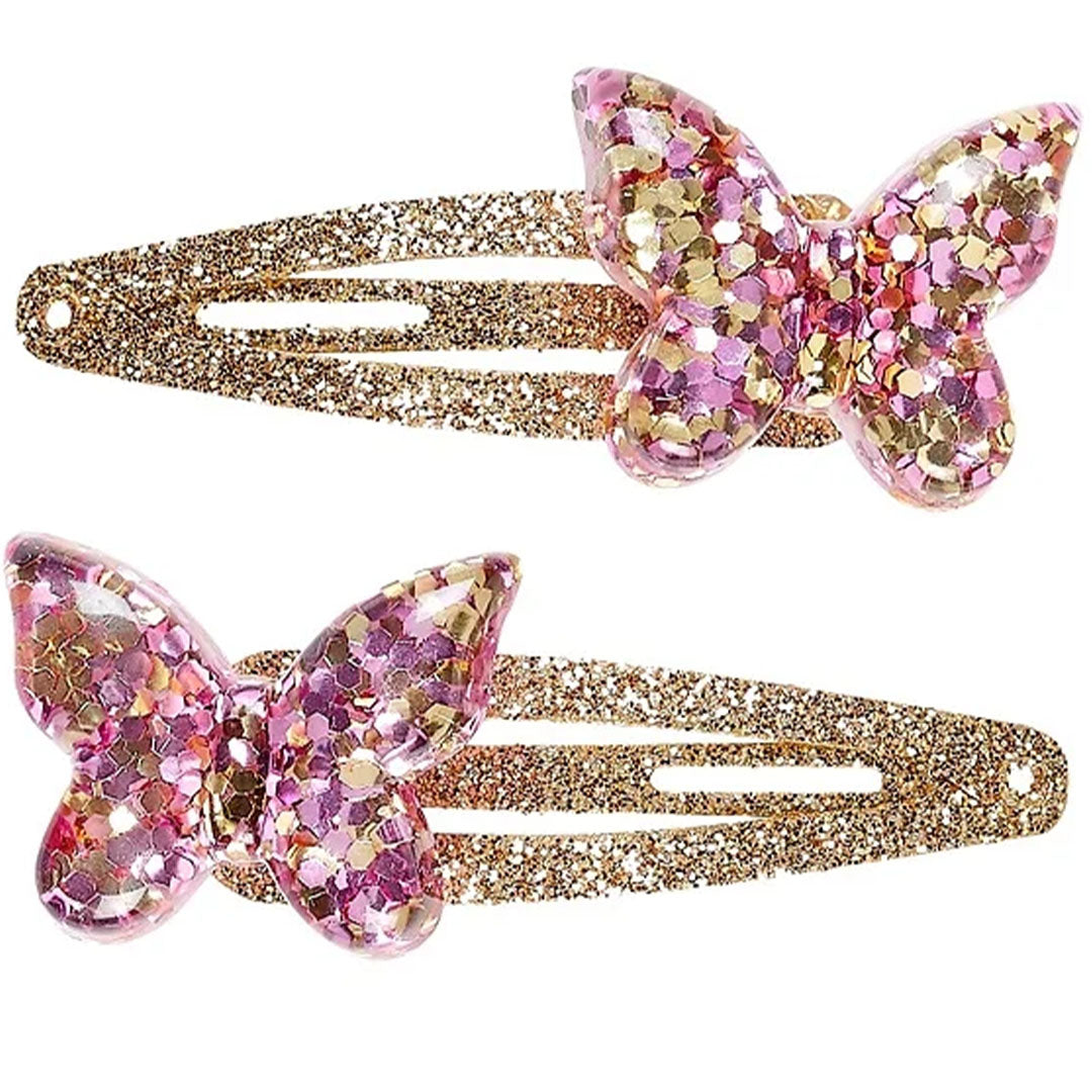 Twee roze en gouden Souza for Kids haarspeldjes met glitter vlinders.