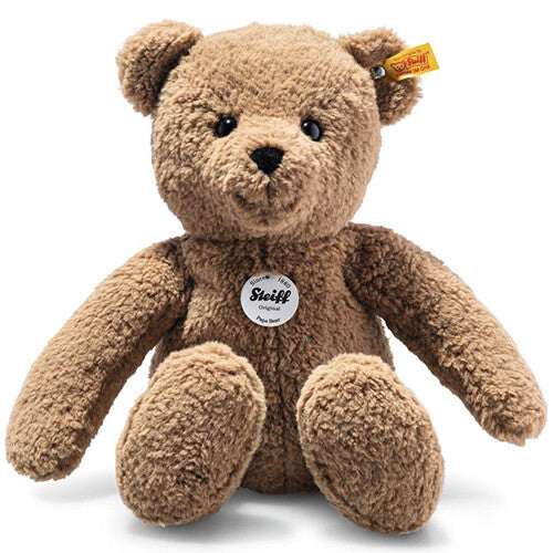 Steiff pluchen teddybeer in bruin, zittend en frontaal gefotografeerd.
