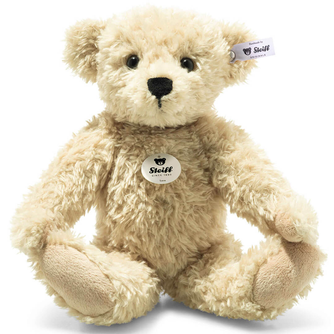 Steiff pluchen teddybeer Luca in beige kleur, zittend afgebeeld.