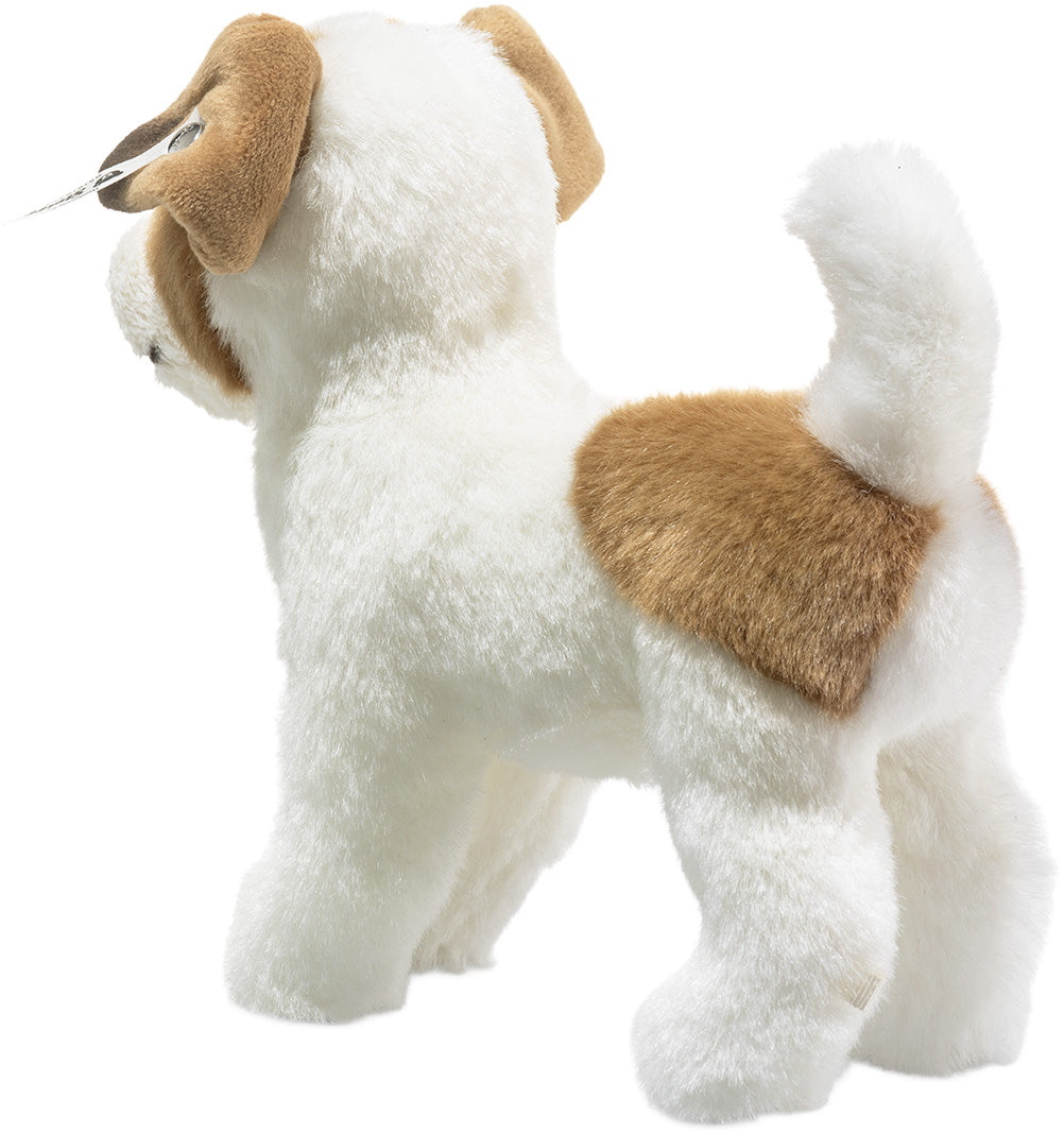 Steiff knuffelhond terriër, wit met bruine vlekken, van achteren en opzij gefotografeerd.