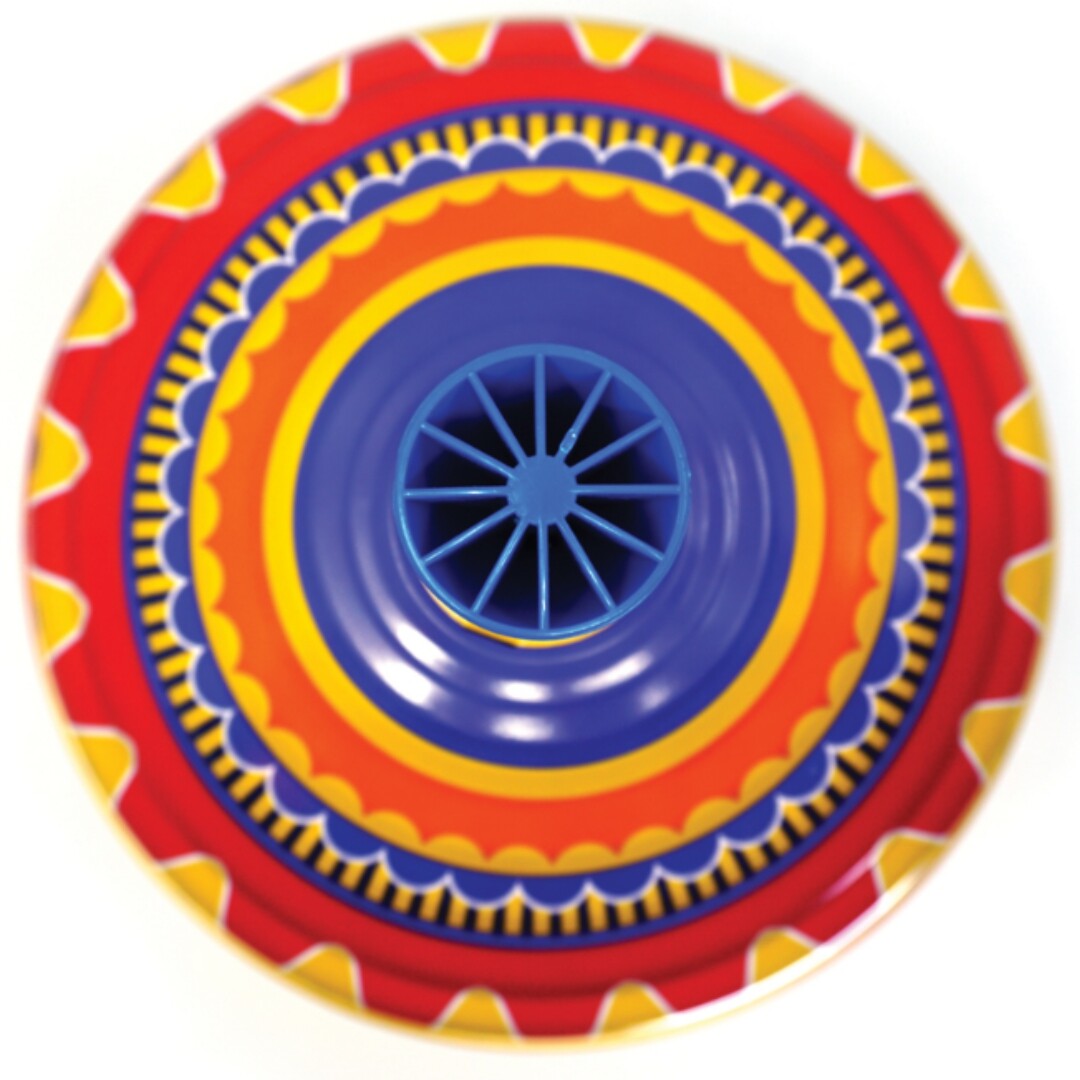 Bovenaanzicht van de bromtol met concentrische cirkels en een blauw mechanisme.