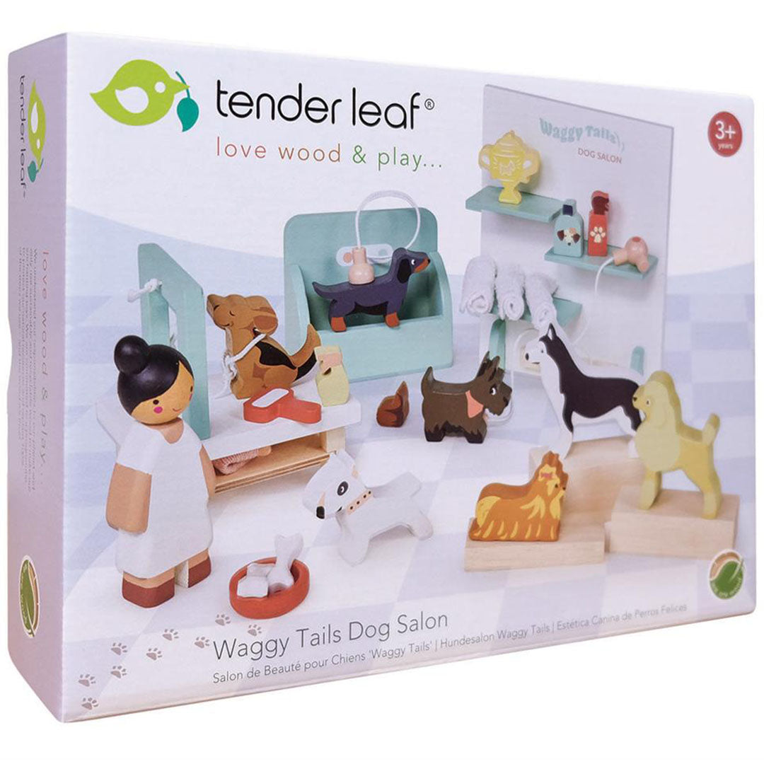 De verpakking van de Tender Leaf Toys houten hondentrimsalon speelset, met een afbeelding van de inhoud en het logo.