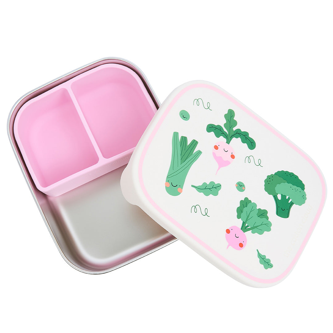 De The Cotton Cloud rvs broodtrommel voor kinderen is open en toont een roze siliconen inzet met twee vakken en de deksel met groentefiguren ernaast.