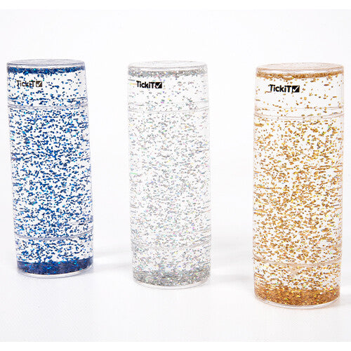 Drie Tickit glittercilinders in blauw, zilver en goud, met de glitters onderin.