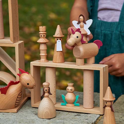 tickit houten sprookjesfiguren zoals een draak, prinses en eenhoorn staan tussen houten bouwblokken.