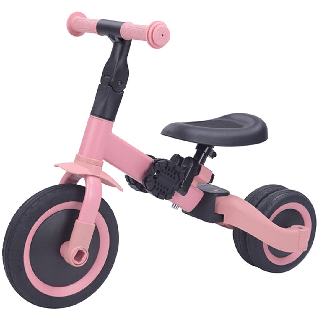 Topmark 4-in-1 roze loopfiets met twee achterwielen dicht bij elkaar, schuin van voren gefotografeerd.