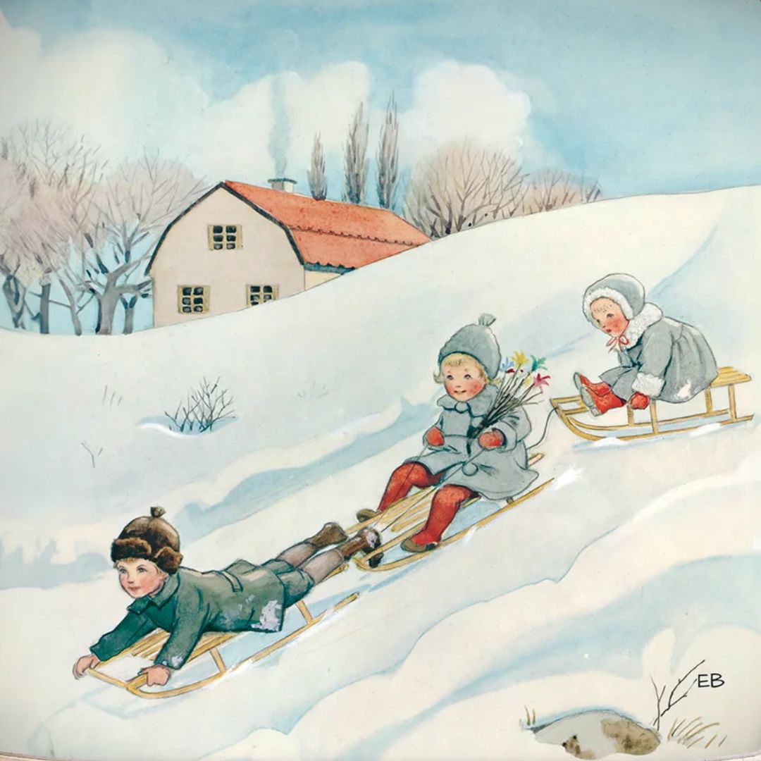 Toverlux toverplaat met illustratie van drie kinderen die van een besneeuwde heuvel sleeën.