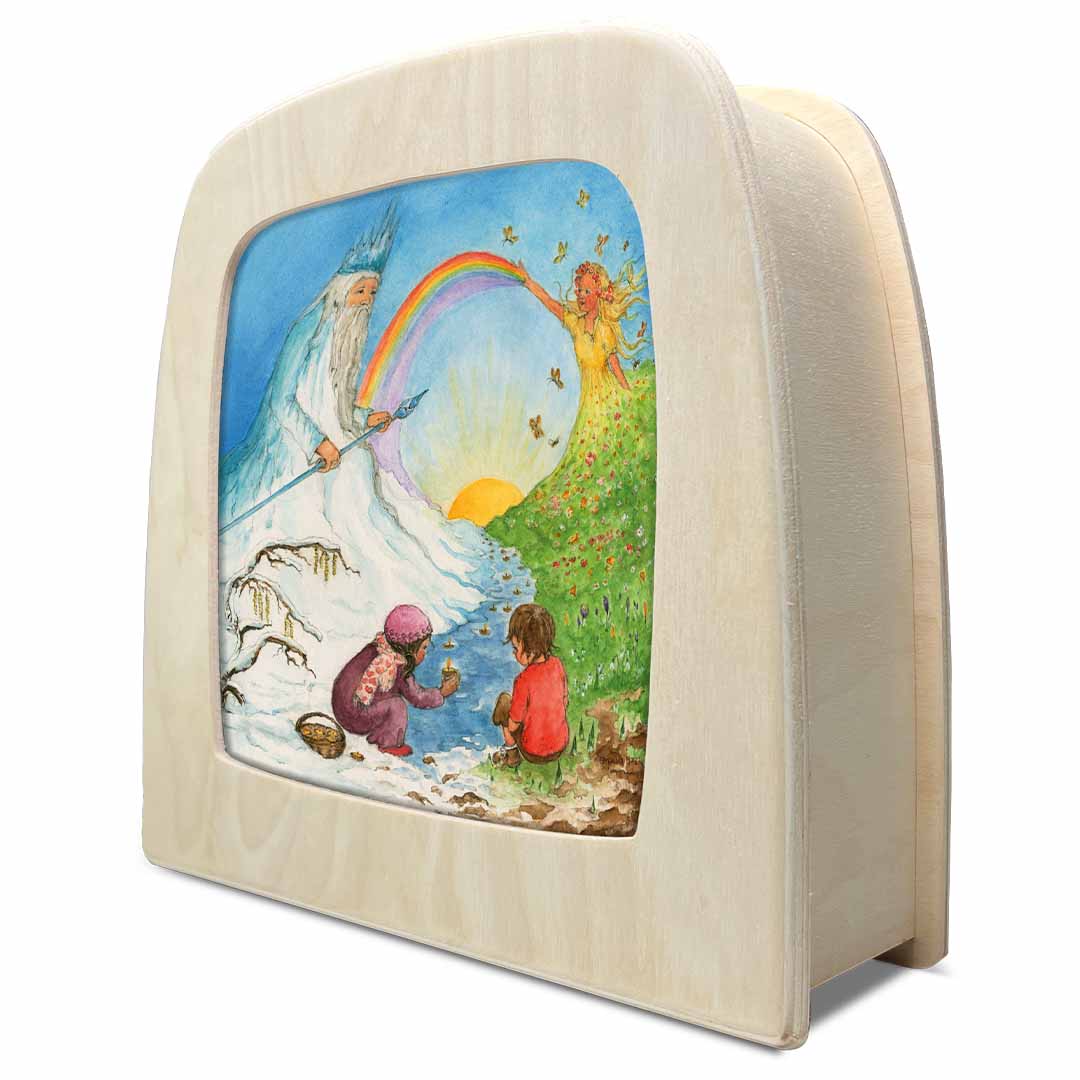 Toverlux toverplaat voor toverlamp, schuin van voren gezien, met een houten frame en de illustratie van de winter-lente overgang.