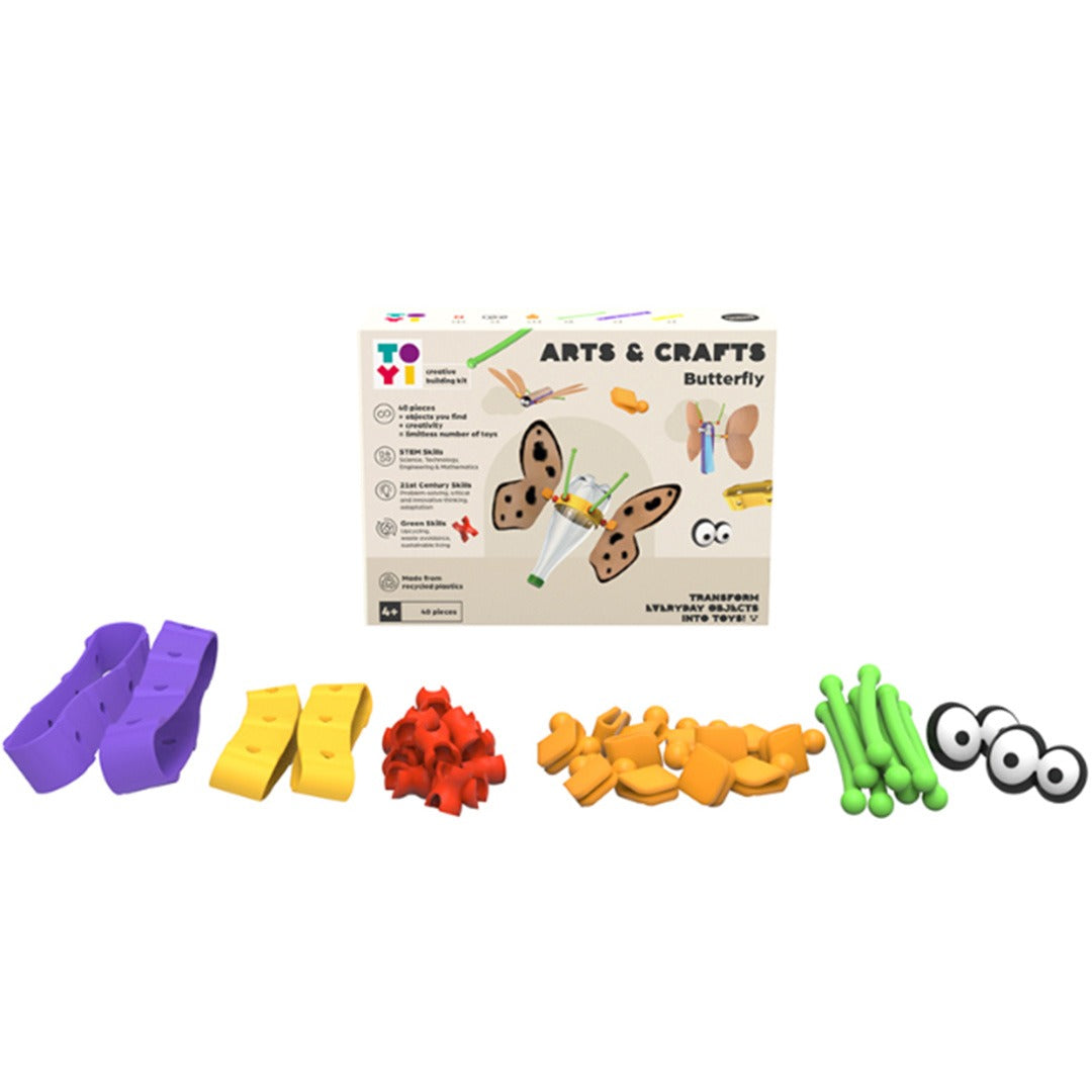 De losse, veelkleurige plastic onderdelen van het TOYI Arts & Crafts Butterfly bouwpakket, met de verpakking op de achtergrond.