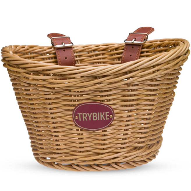 Trybike gevlochten kinderfietsmandje met leren riempjes en merklabel.