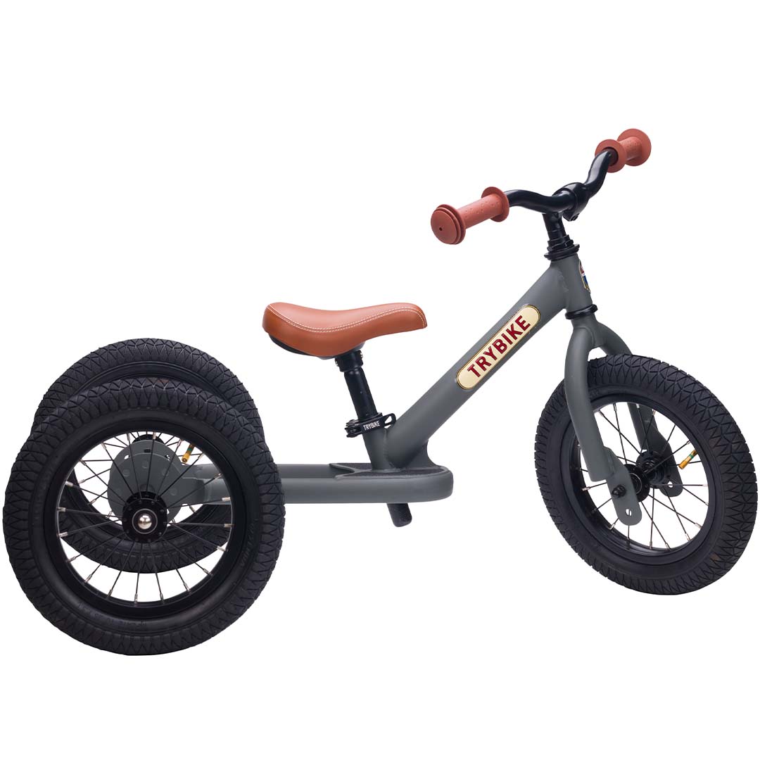 Trybike stalen 2-in-1 loopfiets in driewielerstand, grijs met bruine accenten.
