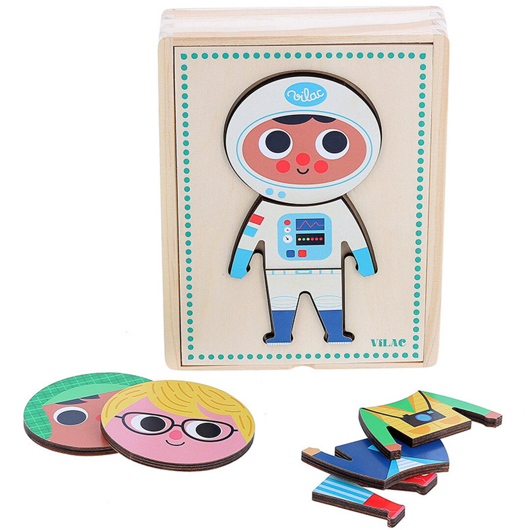 De Vilac houten aankleedpuzzel met een jongen in astronautenpak op de doos, en losse hoofden en kledingstukken ernaast.