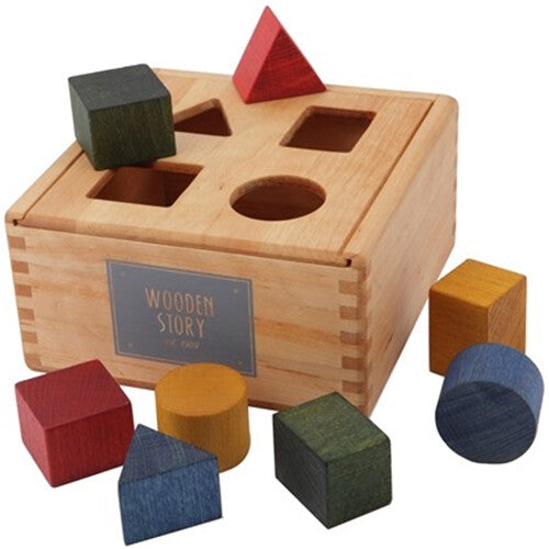 Wooden Story houten vormenstoof met veelkleurige blokken, waarvan enkele in de sorteerdoos en andere ernaast liggen, geschikt als babyspeelgoed.