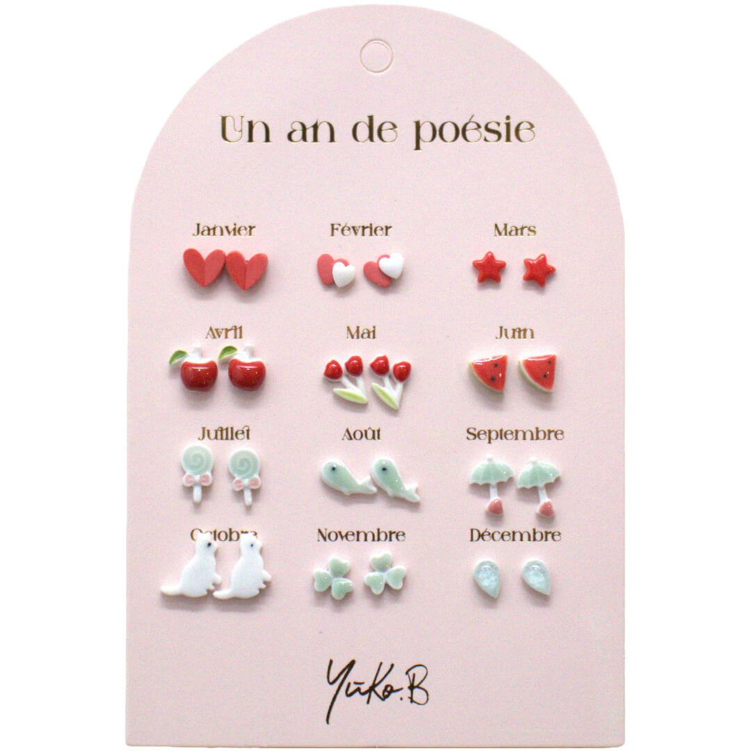 Yuko B. kinder oorbellen set met 12 paar verschillende oorbellen, elk voor een maand van het jaar, op een roze kaart.